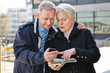 Senior couple as tourists with map