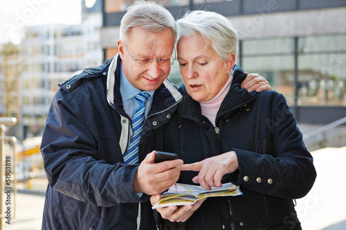 Photo: Senior couple as tourists with map Senior couple as tourists with map