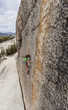 Female climber gripping the rock.