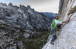 Climber scales a cliff.