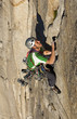 Climber scales a cliff.