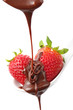 molten chocolate being poured over two small organic strawberrie