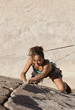 Female climber gripping the rock.