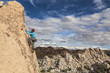 Female climber gripping the rock.