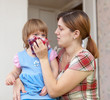 woman wipes snot her child