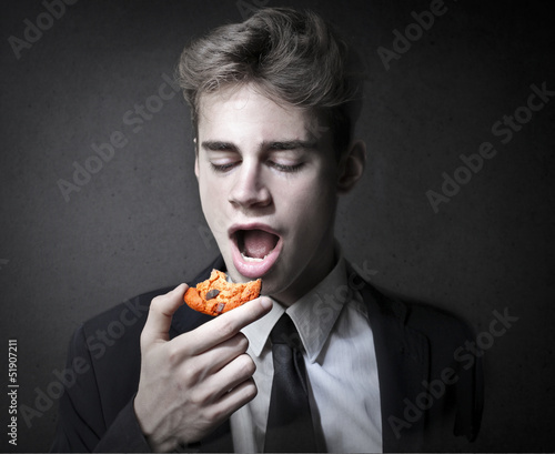 Photo: man eats cookie man eats cookie