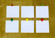 Note paper with  pins on a wooden board