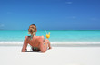 Girl with a glass of orange on the beach of Exuma, Bahamas