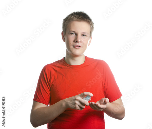Photo: The boy, the teenager spraying fragrance perfume The boy, the teenager spraying fragrance perfume