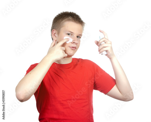 Photo: The boy,the teenager with a cream for a problem youthful skin The boy,the teenager with a cream for a problem youthful skin