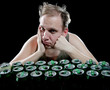 Photo: Hangover. Unhealthy man and beer cans Hangover. Unhealthy man and beer cans