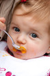 Feeding pretty baby outdoors