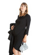 A pregnant woman, 9 months, holding her tummy