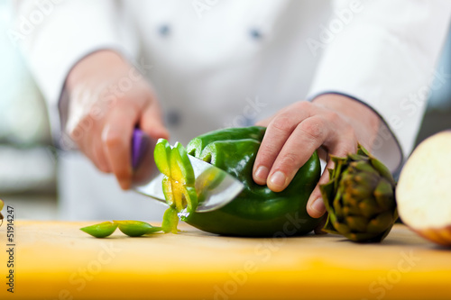 Photo: Chef cutting a pepper Chef cutting a pepper