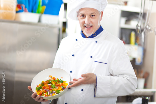 Photo: Chef showing a salad Chef showing a salad