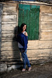 pretty young girl in front of old house