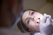 Young woman in dental clinic with dentist checking teeth hygiene