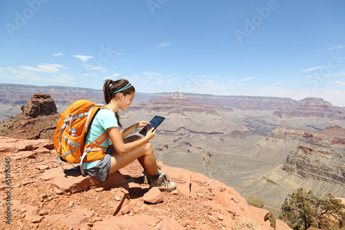 Photo: Tablet computer woman hiking in Grand Canyon Tablet computer woman hiking in Grand Canyon
