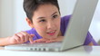 Mixed race Asian woman using laptop computer