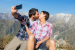 Couple Taking Self Portrait at Top of Mountain