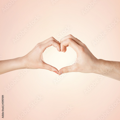 Photo: woman and man hands showing heart shape woman and man hands showing heart shape