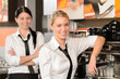 Two waitresses posing in coffee house