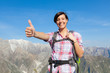 Photo: Young Woman with Thumbs Up at Top of Mountain Young Woman with Thumbs Up at Top of Mountain