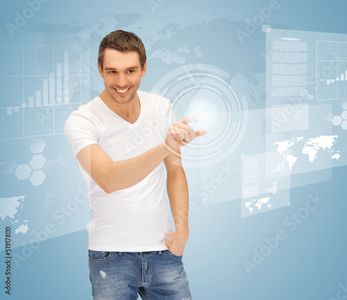 Photo: man touching virtual screen man touching virtual screen