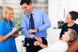 doctor and nurse recording senior patient's pulse