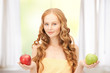 young beautiful woman with green and red apples