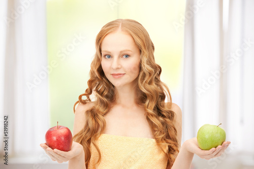 Photo: young beautiful woman with green and red apples young beautiful woman with green and red apples