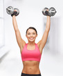 woman with heavy steel dumbbells