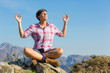 Young Woman Relaxing on Top of Mountain
