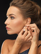 woman wearing shiny diamond earrings