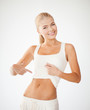 beautiful sporty woman pointing at abs