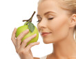 woman smelling apple