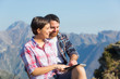 Couple with Digital Tablet at Top of Mountain