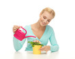 housewife with flower in pot and watering can