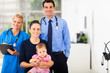 medical professionals with mother and baby girl