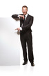 Portrait of business man showing blank signboard