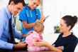 male doctor examining a baby girl