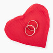 Foto: Big red heart from the fabric, two gold wedding rings on the Big red heart from the fabric, two gold wedding rings on the