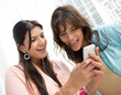 Photo: Women using app on a cell phone Women using app on a cell phone