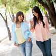 Photo: Girls using a mobile phone Girls using a mobile phone