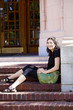 Photo: Young teen girl enjoying sunshine, sitting on brick steps outdoo Young teen girl enjoying sunshine, sitting on brick steps outdoo