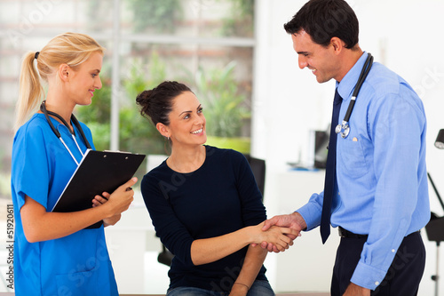 Photo: woman handshaking with doctor after checkup woman handshaking with doctor after checkup