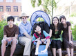Father sitting with his biracial children and disabled son