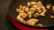 browning chicken in a frying pan on the stove