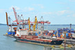 Container stack and ship under crane bridge