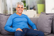 Photo: middle aged man relaxing on sofa middle aged man relaxing on sofa